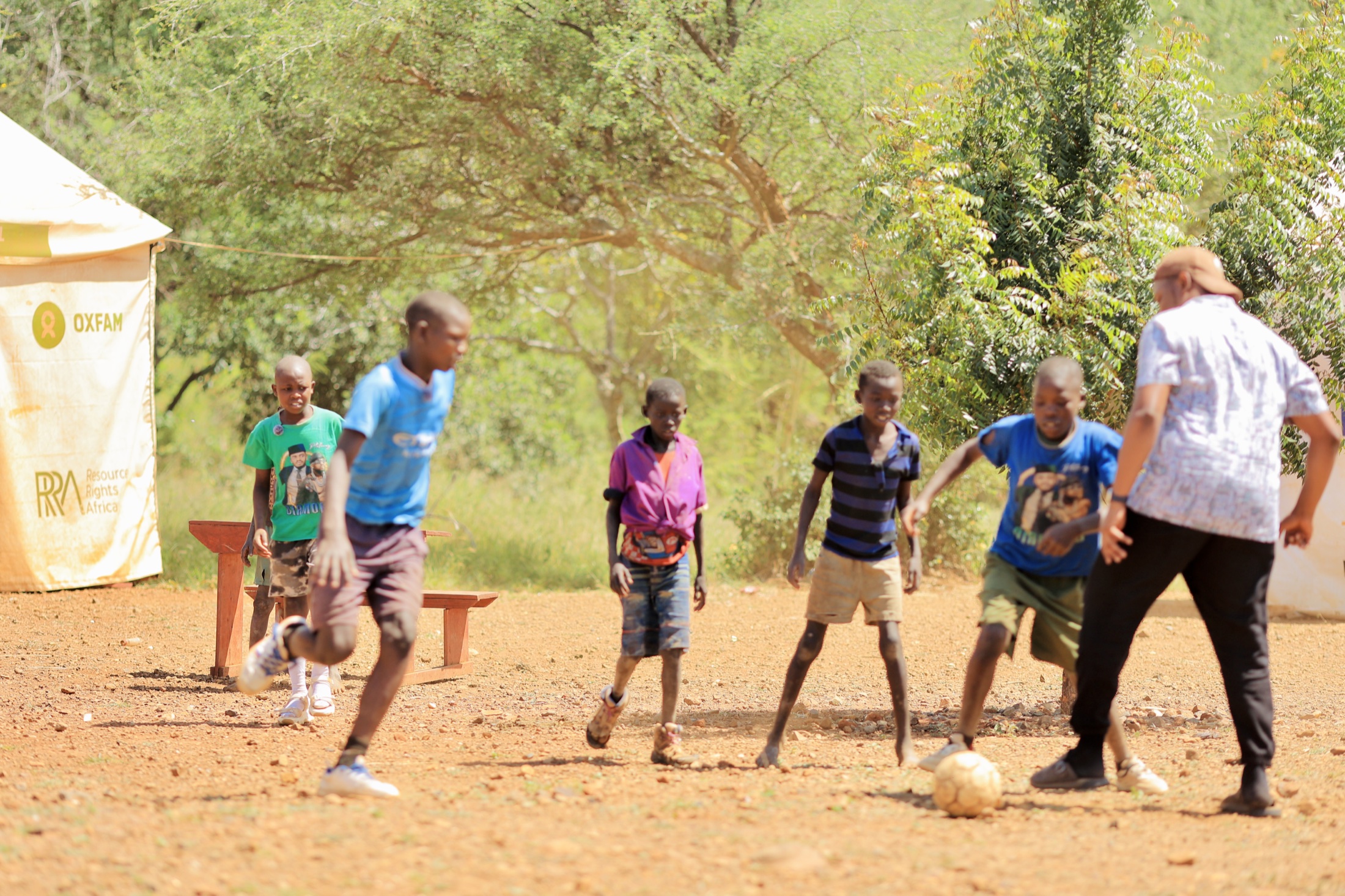 Children playing football near the community school