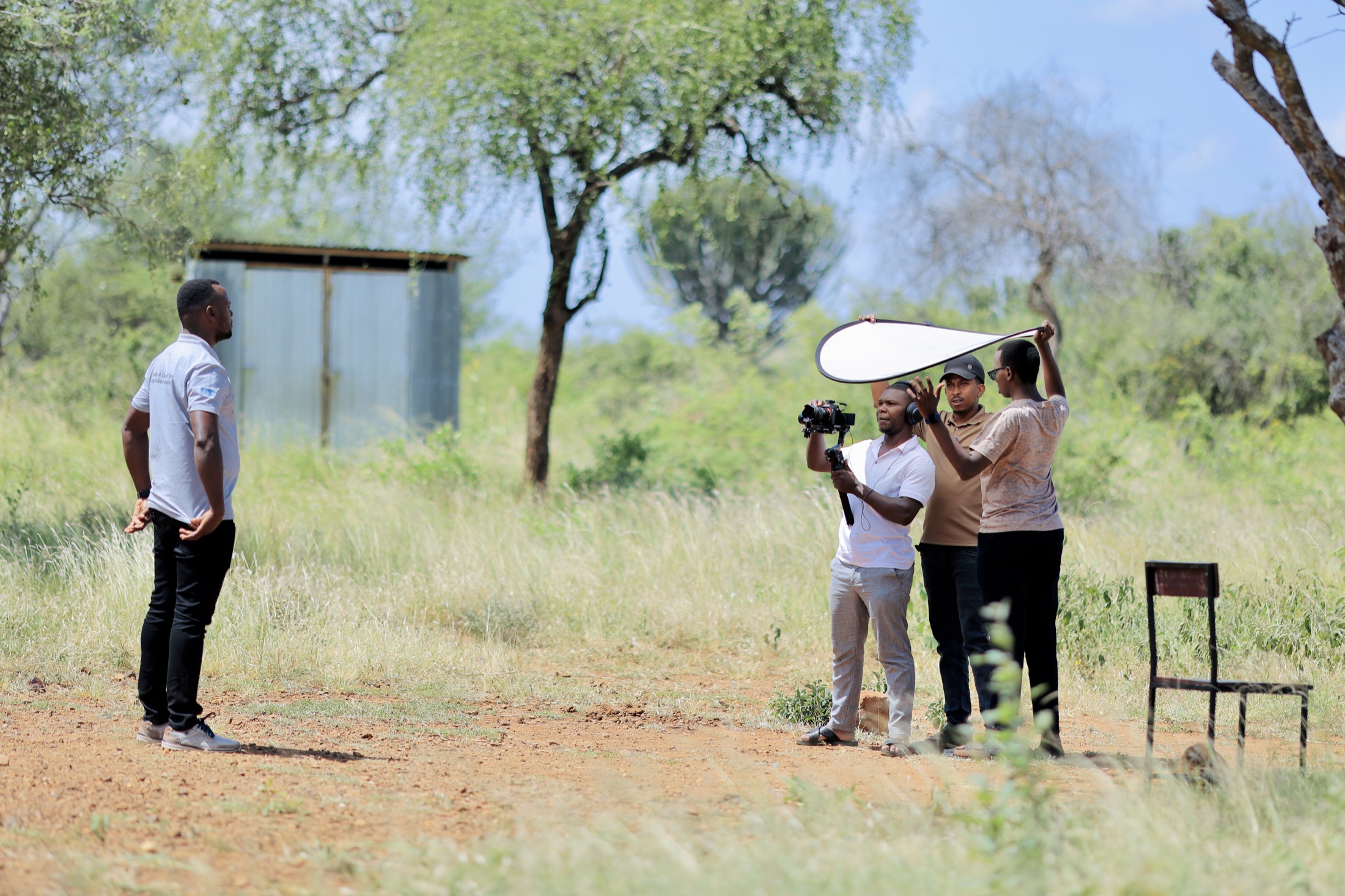 Documentary crew filming a contributor in the Napedo landscape